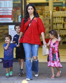 Happy family_ The Brazilian beauty stopped by a pharmacy and emerged clutching a brown paper bag while her children walked by her side.jpg
