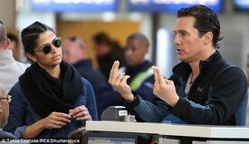 Two options_ Matthew appeared to be deep in-discussion with an attendant at the check-in desk, while Camila listened intently.jpg