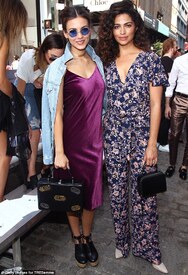 Glittering company_ She posed alongside actress Victoria Justice, who wore a purple dress with a bit of sheen and round blue sunglasses.jpg