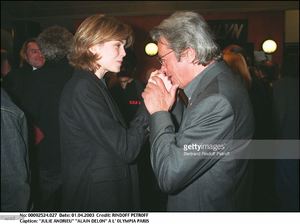 julie-andrieu-alain-delon-at-the-olympia-of-paris-man-woman-hugging-picture-id163331613.jpg