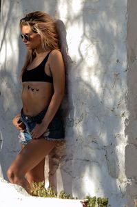 lottie-moss-in-ripped-jean-shorts-and-a-sports-bra-beach-in-mykonos-07-29-2017-5.jpg