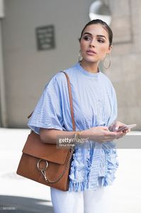 olivia-culpo-is-wearing-ports-1961-top-unravel-denim-chloe-bag-boots-picture-id541162060.jpg