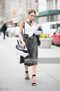 olivia-culpo-is-wearing-tods-skirt-and-bag-jbrand-tshirt-unravel-bra-picture-id519456444.jpg