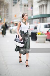 olivia-culpo-is-wearing-tods-skirt-and-bag-jbrand-tshirt-unravel-bra-picture-id519456452.jpg