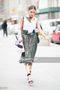 olivia-culpo-is-wearing-tods-skirt-and-bag-jbrand-tshirt-unravel-bra-picture-id519456490.jpg