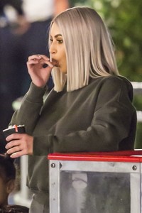 kim-kardashian-in-grey-hoodie-ice-skating-at-a-christmas-party-in-thousand-oaks-4.jpg