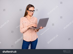 stock-photo-charming-clever-lady-in-a-beige-formal-smart-casual-shirt-is-standing-on-the-pure-grey-background-727157965.jpg