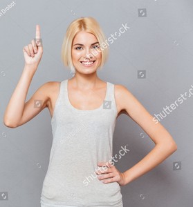 stock-photo-smiling-cute-young-woman-pointing-up-over-gray-background-479554687.jpg