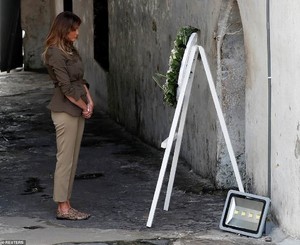 4728644-6235045-The_First_Lady_takes_a_moment_to_reflect_in_front_of_a_wreath_at-m-3_1538568548218.jpg