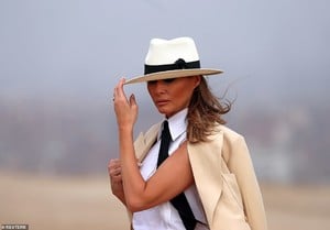 4820374-6247263-The_First_Lady_paired_a_tan_linen_blazer_white_pants_and_Chanel_-a-32_1538842993175.jpg