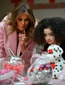 9835996-6706455-How_about_that_one_Melania_assisted_a_line_of_children_in_fillin-a-20_1550184059229.jpg