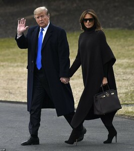 9880696-6710843-President_Donald_Trump_and_first_lady_Melania_Trump_hold_hands_a-a-23_1550272315429.jpg