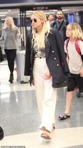 11768900-6877767-Jet_setting_chic_Ashlee_34_was_seen_in_some_cream_high_waist_pan-a-23_1554231809170.jpg