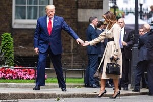 14348444-7102755-Watch_your_step_The_President_offered_a_hand_to_his_wife_as_she_-a-63_1559647418224.jpg