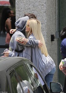 14866688-7148057-Stepping_out_Khloe_was_wearing_a_low_cut_grey_top_under_an_overs-a-10_1560733717619.jpg