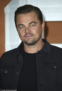 15944828-7239221-Cool_Leo_The_Wolf_of_Wall_Street_actor_wore_all_black_in_a_tee_j-a-65_1562899915275.jpg