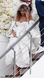 16852318-7318011-Glittering_bride_Giving_her_wedding_ensemble_an_elegant_flourish-a-122_1564858942708.jpg