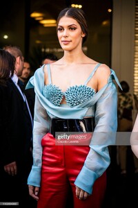 iris-mittenaere-wearing-a-light-blue-decorated-top-red-leather-pants-picture-id1162694965.jpg