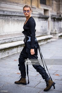 chloe-lecareux-wearing-a-black-top-black-belt-black-pants-and-brown-picture-id1177664058.jpg