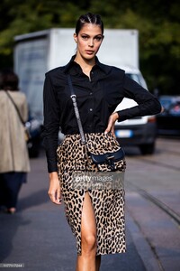 iris-mittenaere-wearing-a-black-shirt-leopard-print-midi-skirt-black-picture-id1177117244.jpg
