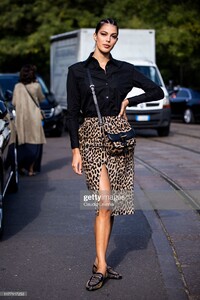 iris-mittenaere-wearing-a-black-shirt-leopard-print-midi-skirt-black-picture-id1177117253.jpg