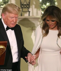 22186498-7787829-The_pair_held_hands_in_front_of_the_podium-a-61_1576225579811.jpg