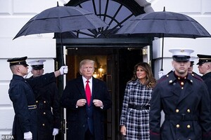 23123808-7862335-Rainy_day_The_president_and_first_lady_braved_the_rain_to_greet_-a-27_1578454905200.jpg