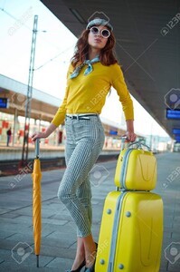 71577639-jolie-femme-adulte-avec-une-valise-près-de-la-gare-sur-la-plate-forme-.jpg