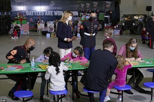 36604276-9030983-She_watches_as_the_children_make_holiday_cards_for_the_troops-a-3_1607468512411.jpeg
