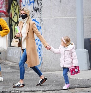 38065768-9153253-Close_The_youngster_held_hands_with_her_famous_mother_who_safely-a-51_1610752524749.jpg