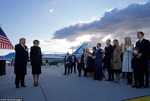 38252706-9167919-Supporters_Melania_stood_by_her_husband_s_side_as_he_greeted_his-a-61_1611155447372.jpg