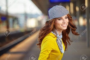 63287592-beautiful-young-woman-with-suitcase-is-waiting-a-train.jpg