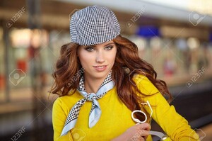 63287616-beautiful-young-woman-with-suitcase-is-waiting-a-train.jpg