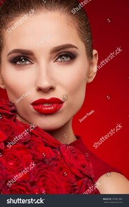 stock-photo-beautiful-surprised-woman-with-red-lips-posing-with-flowers-in-the-studio-on-a-valentines-day-579381886.jpg
