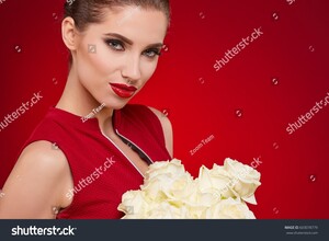 stock-photo-portrait-of-a-beautiful-young-smiling-woman-holding-bunch-of-white-roses-and-looking-at-camera-603078779.jpg
