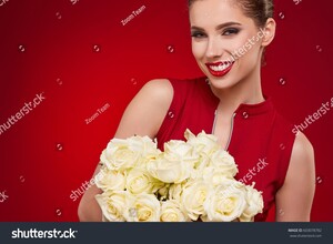 stock-photo-portrait-of-a-beautiful-young-smiling-woman-holding-bunch-of-white-roses-and-looking-at-camera-603078782.jpg