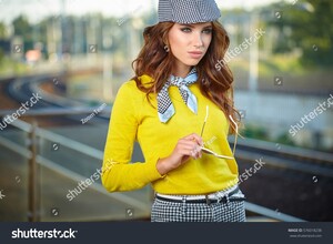 stock-photo-pretty-adult-woman-with-a-suitcase-near-the-train-on-the-platform-576018238.jpg