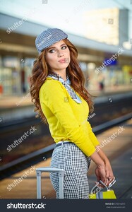 stock-photo-pretty-adult-woman-with-a-suitcase-near-the-train-on-the-platform-576018259.jpg