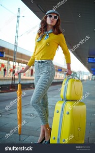 stock-photo-pretty-adult-woman-with-a-suitcase-near-the-train-on-the-platform-576018316.jpg