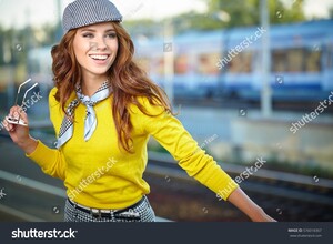 stock-photo-pretty-adult-woman-with-a-suitcase-near-the-train-on-the-platform-576018367.jpg