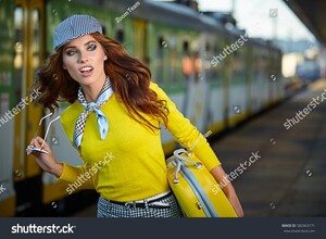 stock-photo-pretty-young-woman-at-a-train-station-color-toned-image-582463171.jpg