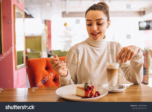 stock-photo-woman-drinking-coffee-with-dessert-in-a-cafe-1082909084.jpg