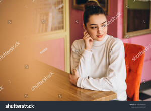 stock-photo-woman-sitting-in-a-cafe-1082909033.jpg