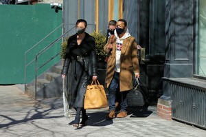 chrissy-teigen-in-a-full-length-black-leather-coat-and-open-toe-high-heels-ny-03-07-2021-4.jpg