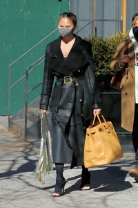 chrissy-teigen-in-a-full-length-black-leather-coat-and-open-toe-high-heels-ny-03-07-2021-9.jpg