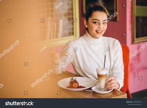 stock-photo-woman-with-coffee-and-dessert-in-a-cafe-1082909162.jpg
