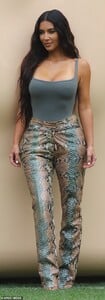 41475880-9447887-Figure_flattering_Kim_put_her_famous_assets_on_display_in_an_oli-a-136_1617846338388.jpg