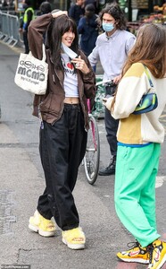 42027674-9494647-Out_and_about_While_in_the_market_Iris_wore_a_brown_jacket_with_-a-9_1618996720195.jpg