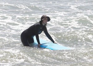 leighton-meester-in-wetsuit-surfing-in-malibu-04-14-2021-1.jpg