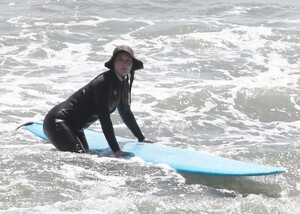 leighton-meester-in-wetsuit-surfing-in-malibu-04-14-2021-5.jpg